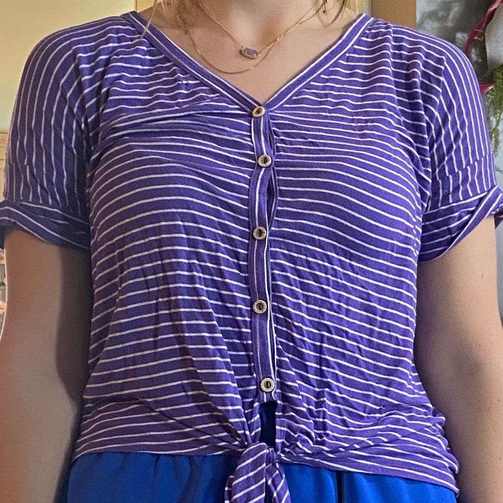 Purple shirts with white strips on it.